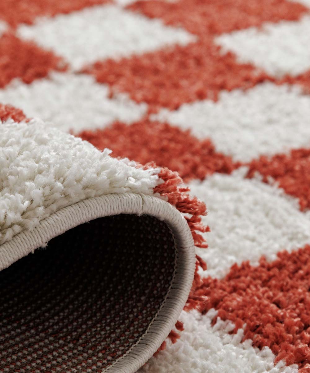 Schachbrett Teppich rund - Check Elfenbein/Koralle - close up Schachbrett Teppich rund - Check Elfenbein/Koralle - close up